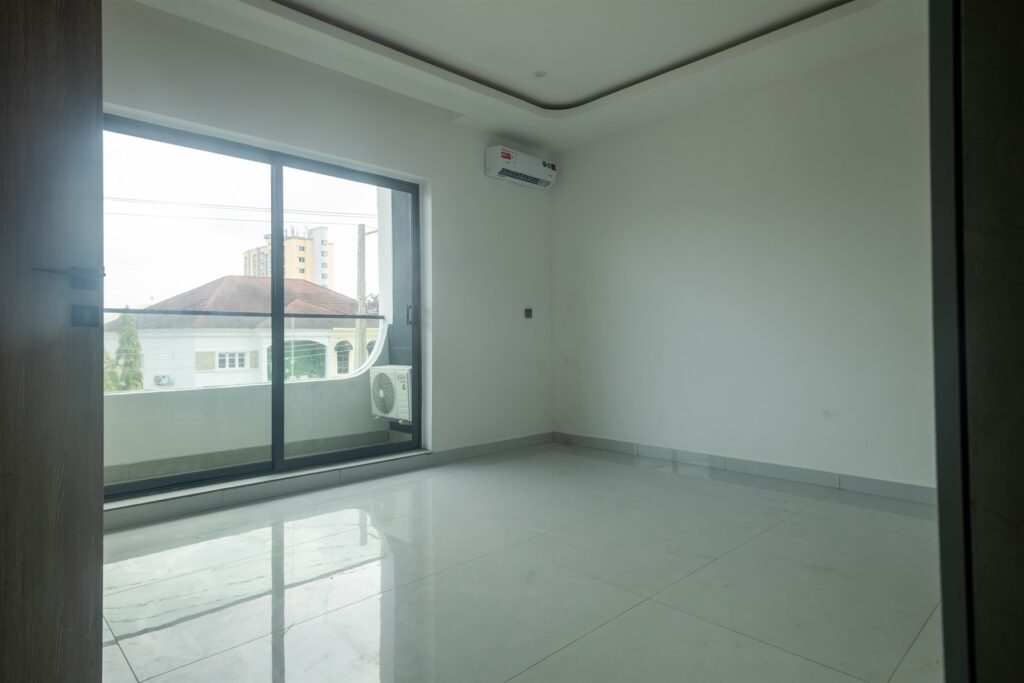 Brum Height 8: Unfurnished bedroom beside sliding balcony doors